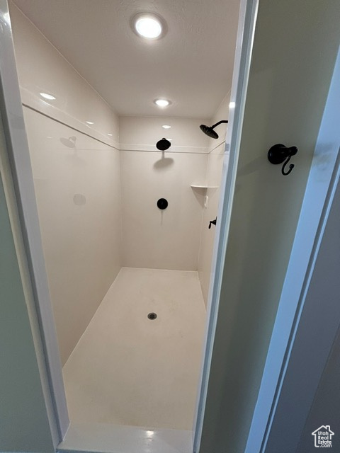 Full bath featuring a shower stall