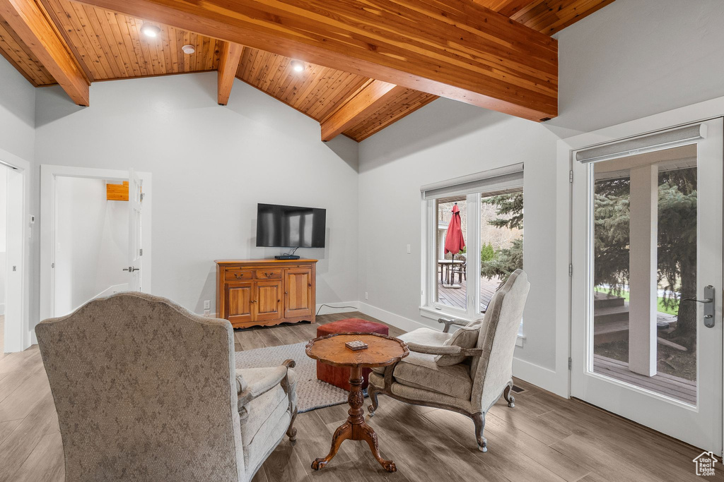 Living room featuring beam ceiling, high vaulted ceiling, recessed lighting, wood ceiling, and light wood-style floors