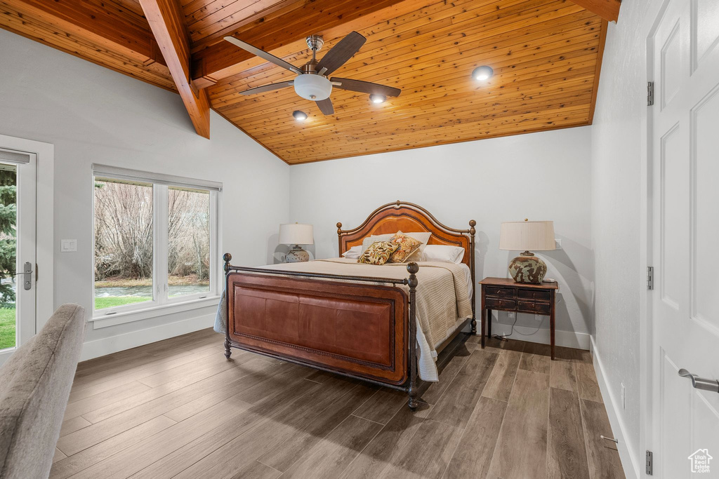 Bedroom with baseboards, multiple windows, lofted ceiling with beams, and wood ceiling