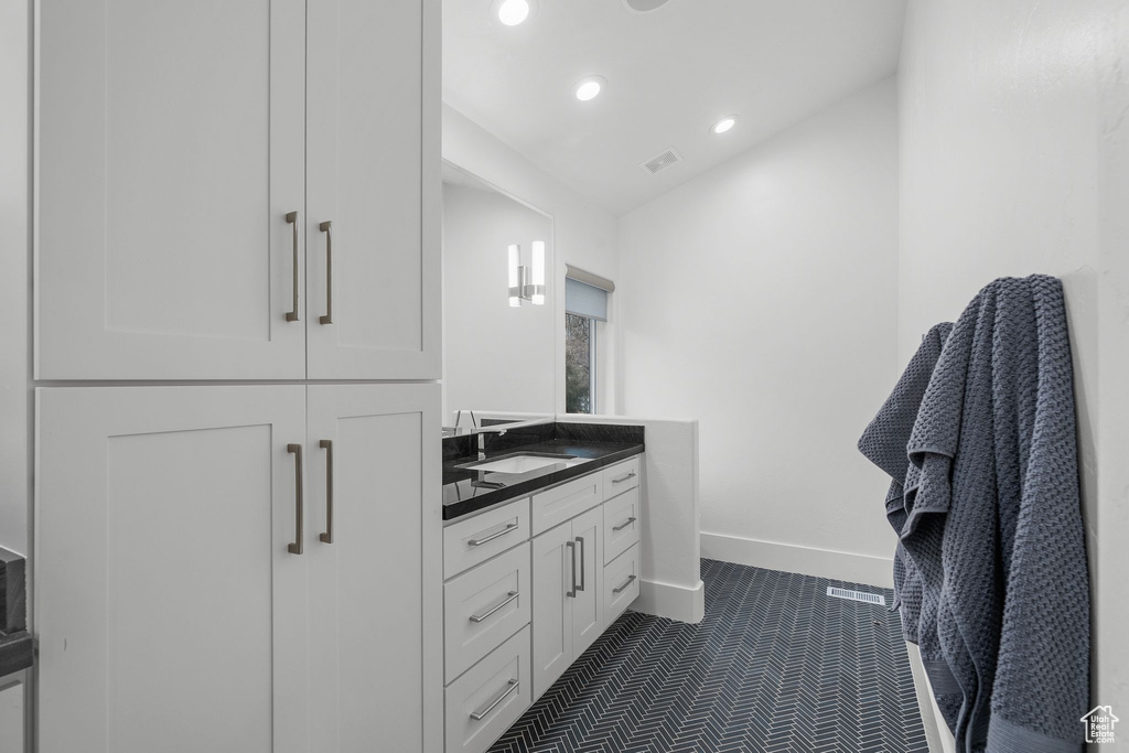 Bathroom with recessed lighting, baseboards, visible vents, tile patterned floors, and vanity