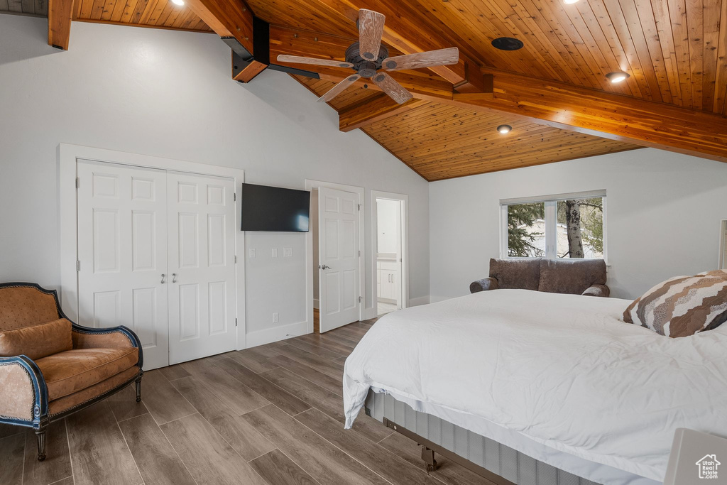 Bedroom with a closet, recessed lighting, wooden ceiling, wood finished floors, and lofted ceiling with beams
