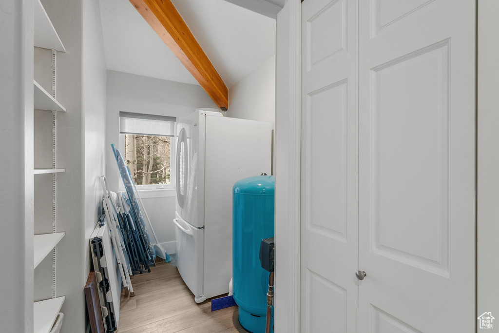 Washroom with light wood finished floors and laundry area