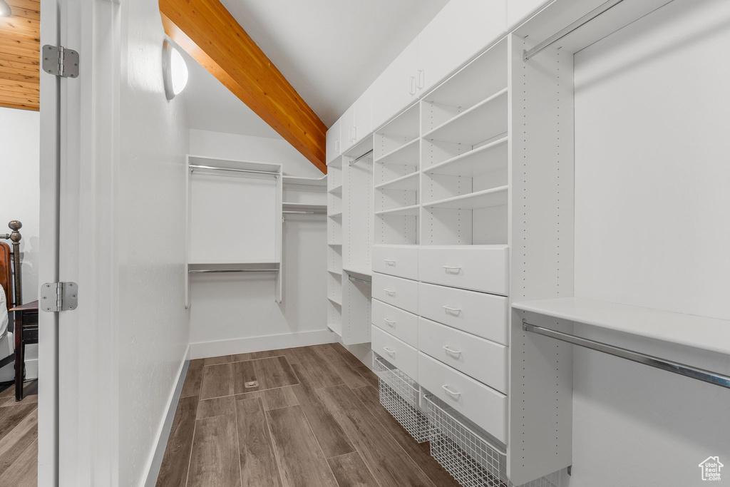 Spacious closet with dark wood-style floors