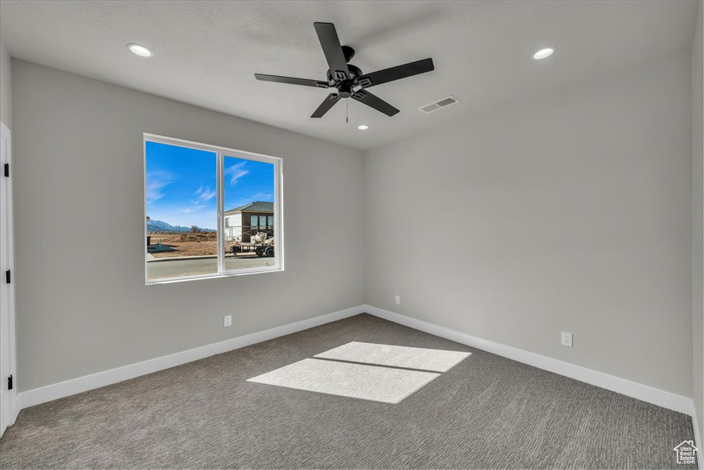 Spare room featuring recessed lighting, carpet, baseboards, ceiling fan, and visible vents
