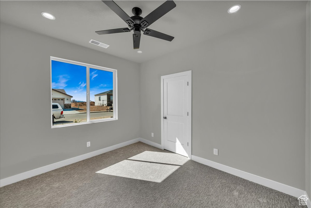 Empty room featuring recessed lighting, ceiling fan, and carpet floors