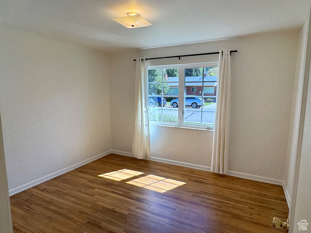 Empty room featuring baseboards and wood finished floors