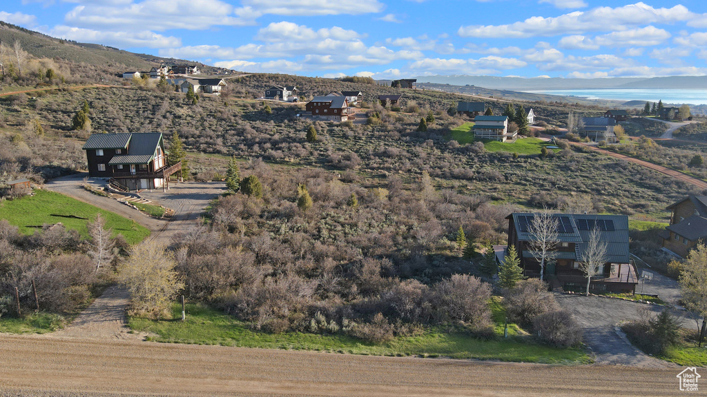Birds eye view of property with a water view