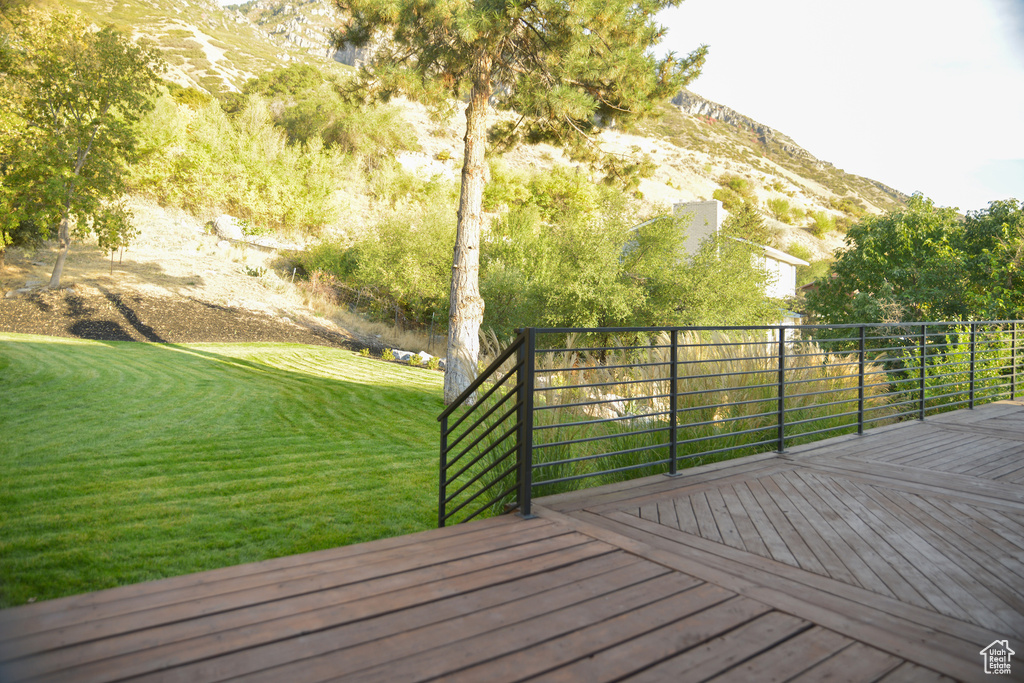 Deck featuring a yard and a mountain view