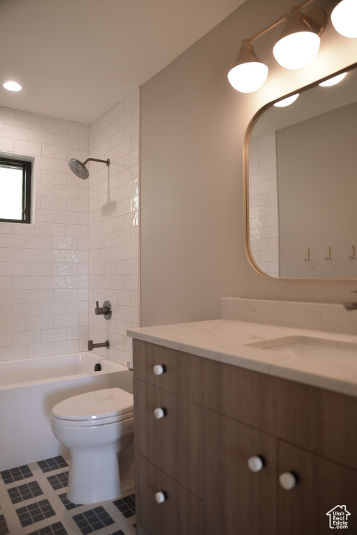 Bathroom with toilet, tile patterned floors, bathing tub / shower combination, and vanity
