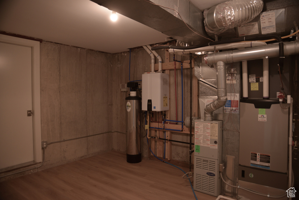Utility room featuring tankless water heater