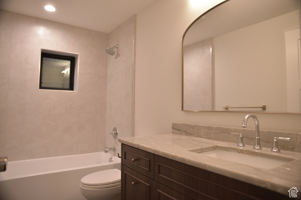 Full bath with vanity,  shower combination, toilet, and recessed lighting