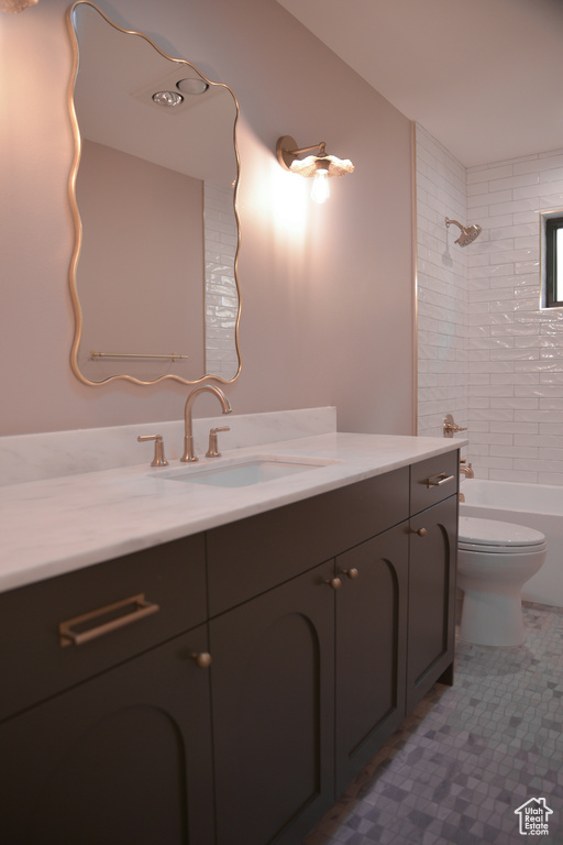 Full bath featuring toilet, vanity, and shower / tub combination