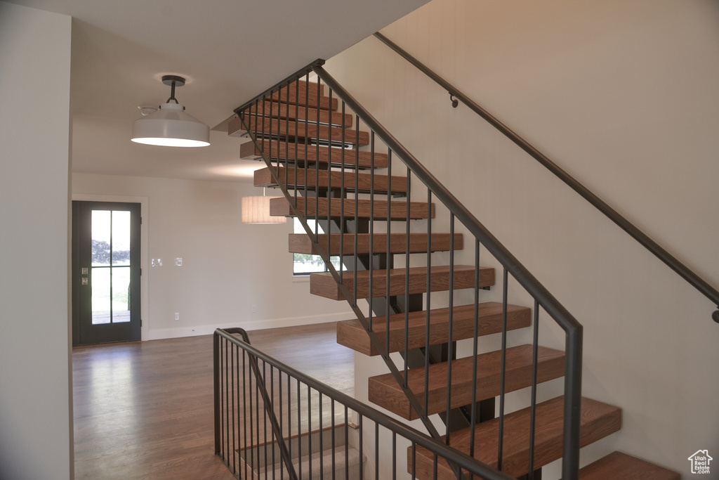 Stairs with baseboards and wood finished floors