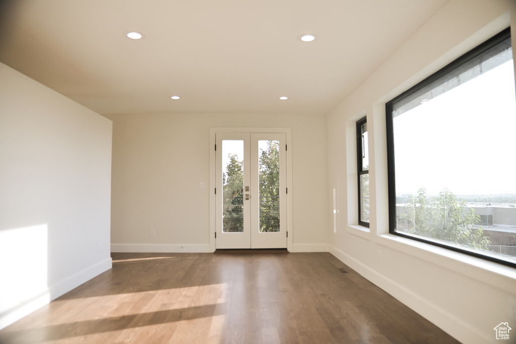 Spare room featuring wood finished floors, baseboards, and recessed lighting