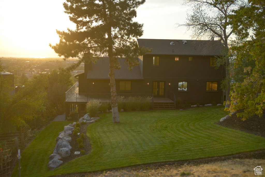 Back of property featuring french doors and a lawn