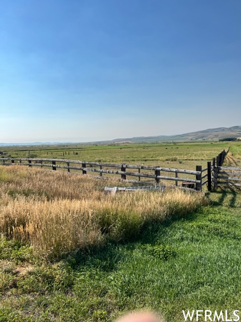 View of yard featuring a rural view and fence