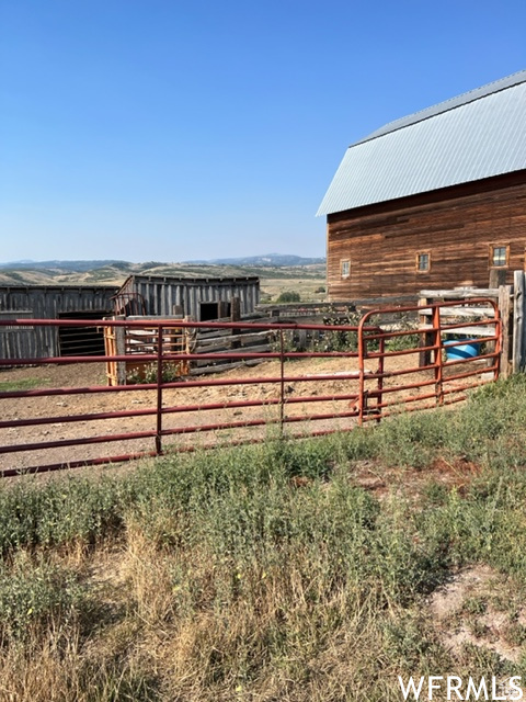 View of horse barn featuring a rural view