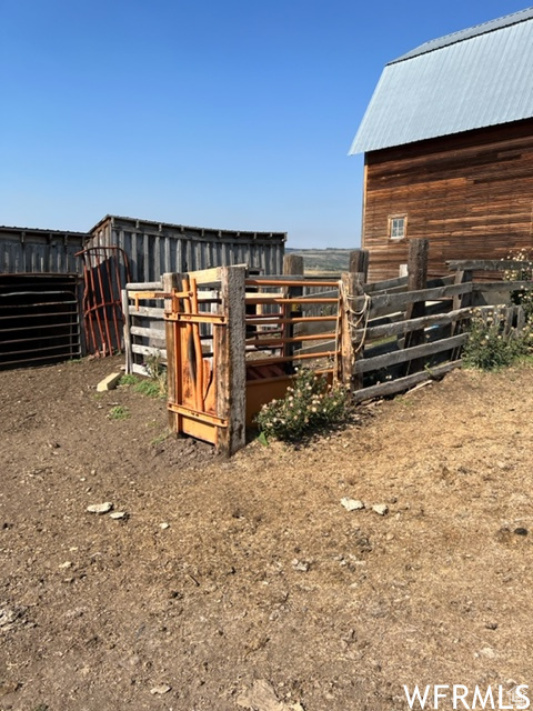 View of yard with an outdoor structure and fence
