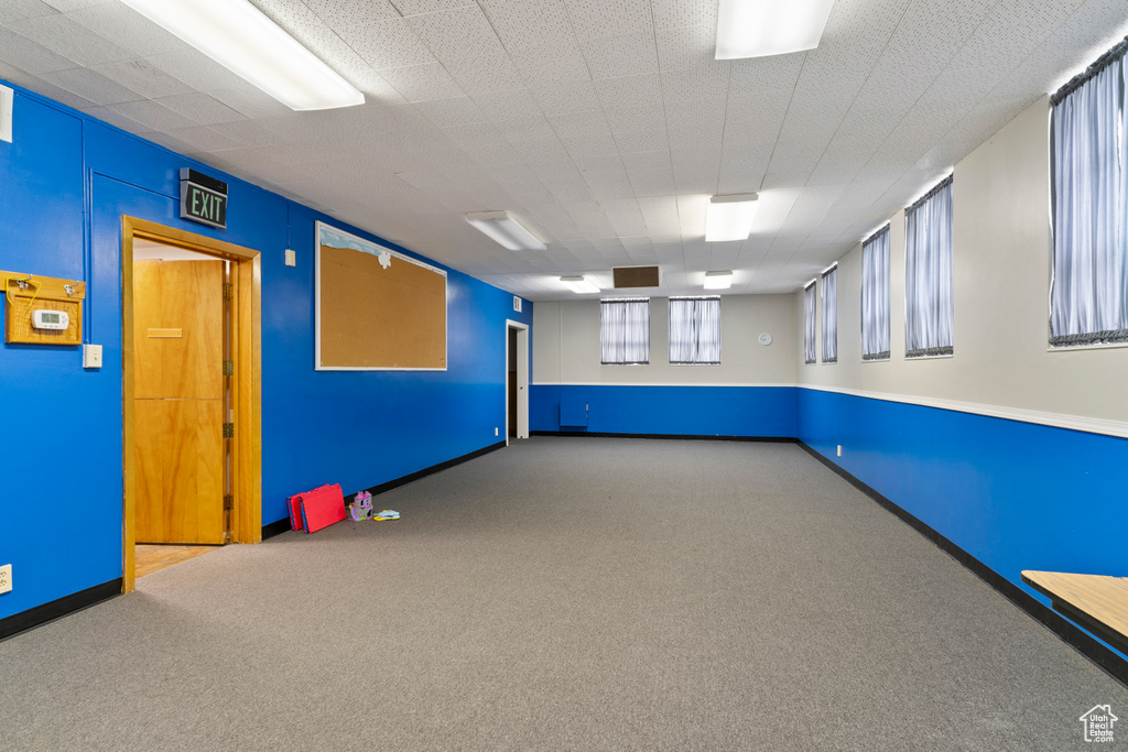 Carpeted empty room featuring baseboards