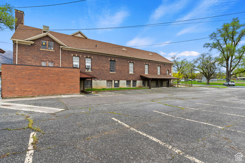 View of property with uncovered parking