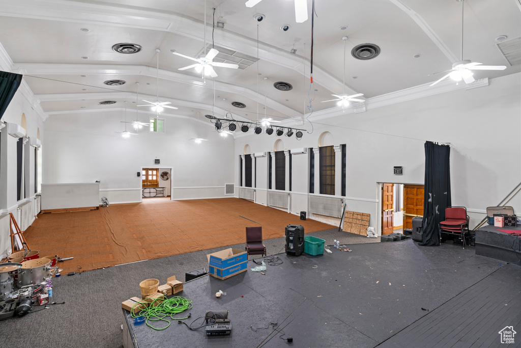 Interior space featuring ceiling fan, high vaulted ceiling, and visible vents