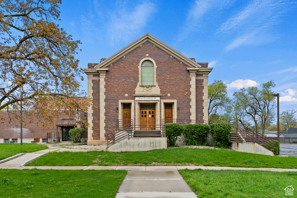 Traditional home with brick siding and a front lawn