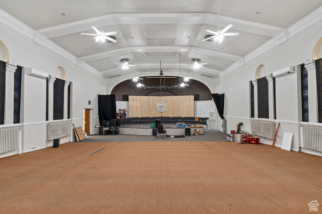Miscellaneous room with visible vents, high vaulted ceiling, a wall unit AC, and a ceiling fan
