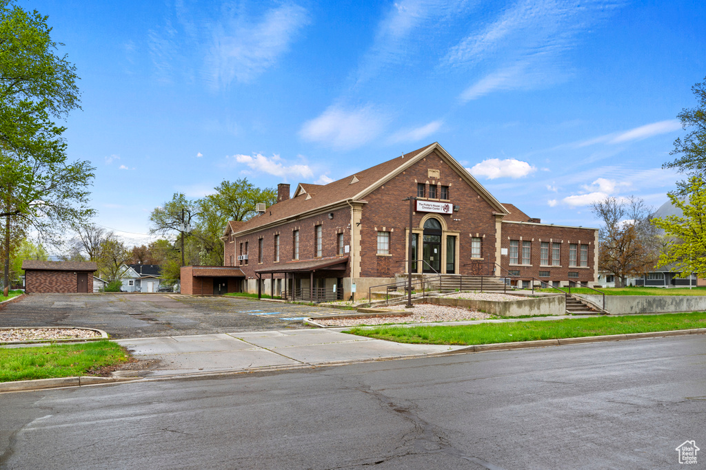 Traditional-style home with a chimney and brick siding