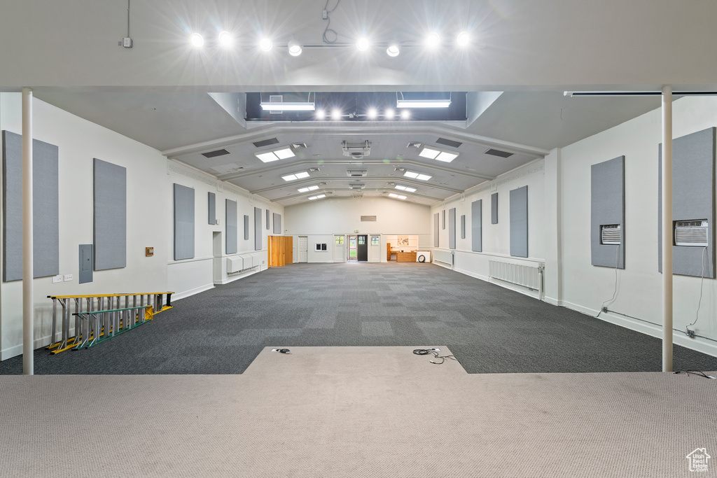 Miscellaneous room with carpet floors and vaulted ceiling