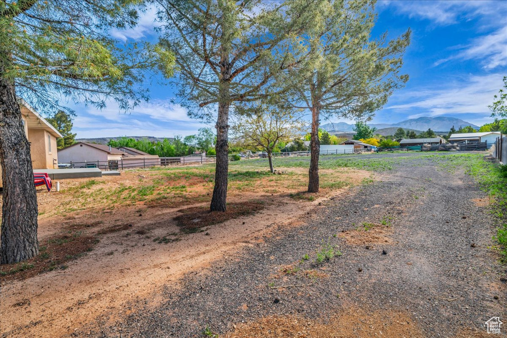 View of road featuring a mountain view and driveway