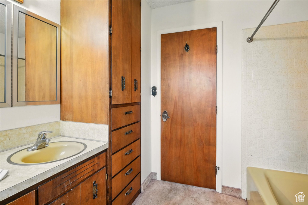 Bathroom with vanity and shower / washtub combination