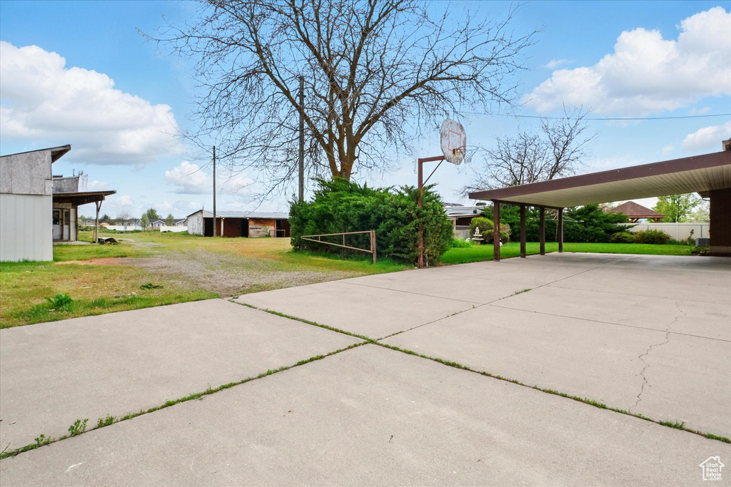 Exterior space featuring concrete driveway and a carport