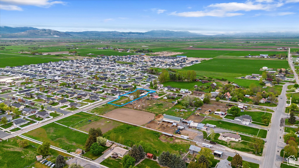 Aerial overview of property's location featuring a mountainous background