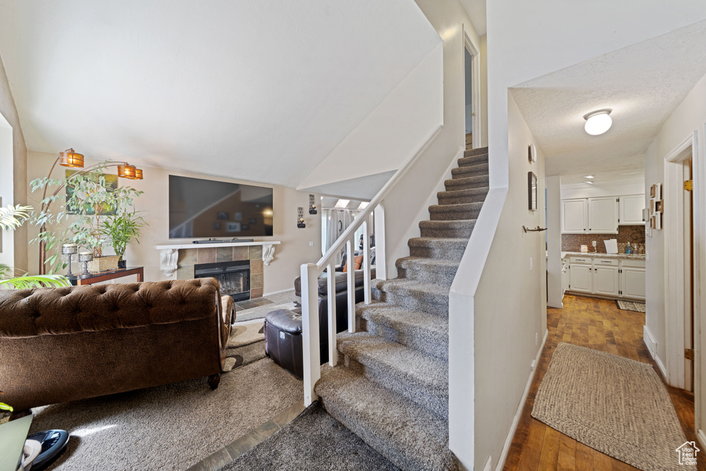 Stairway featuring a fireplace and wood finished floors