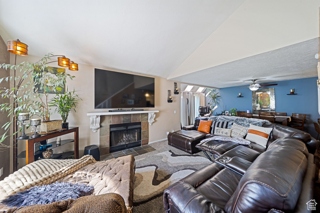Carpeted living room featuring a tile fireplace