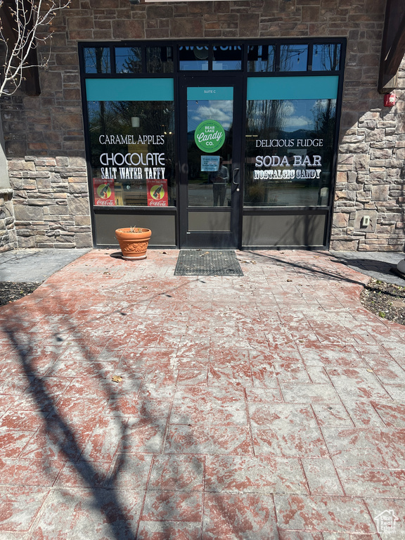 Doorway to property with stone siding