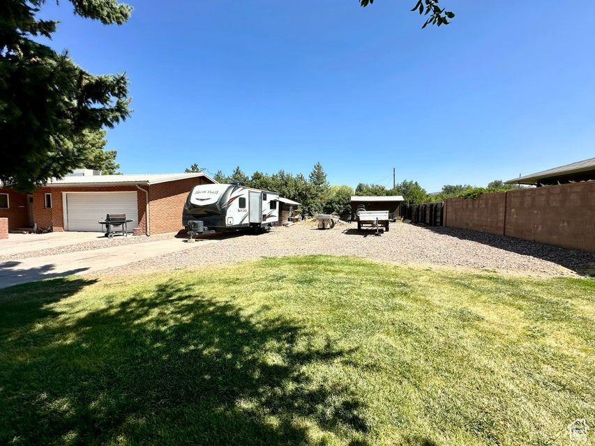 View of yard featuring fence