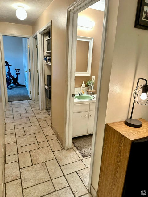Hallway featuring a sink