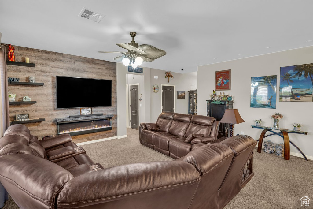 Living area with baseboards, ceiling fan, visible vents, an accent wall, and carpet floors