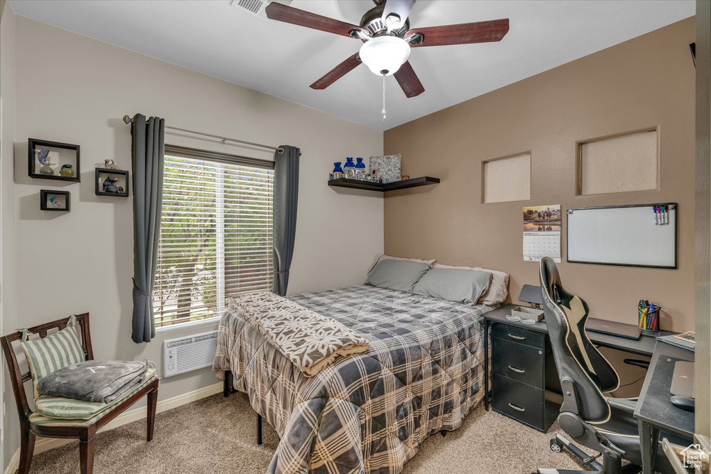 Bedroom with light colored carpet, baseboards, and a ceiling fan