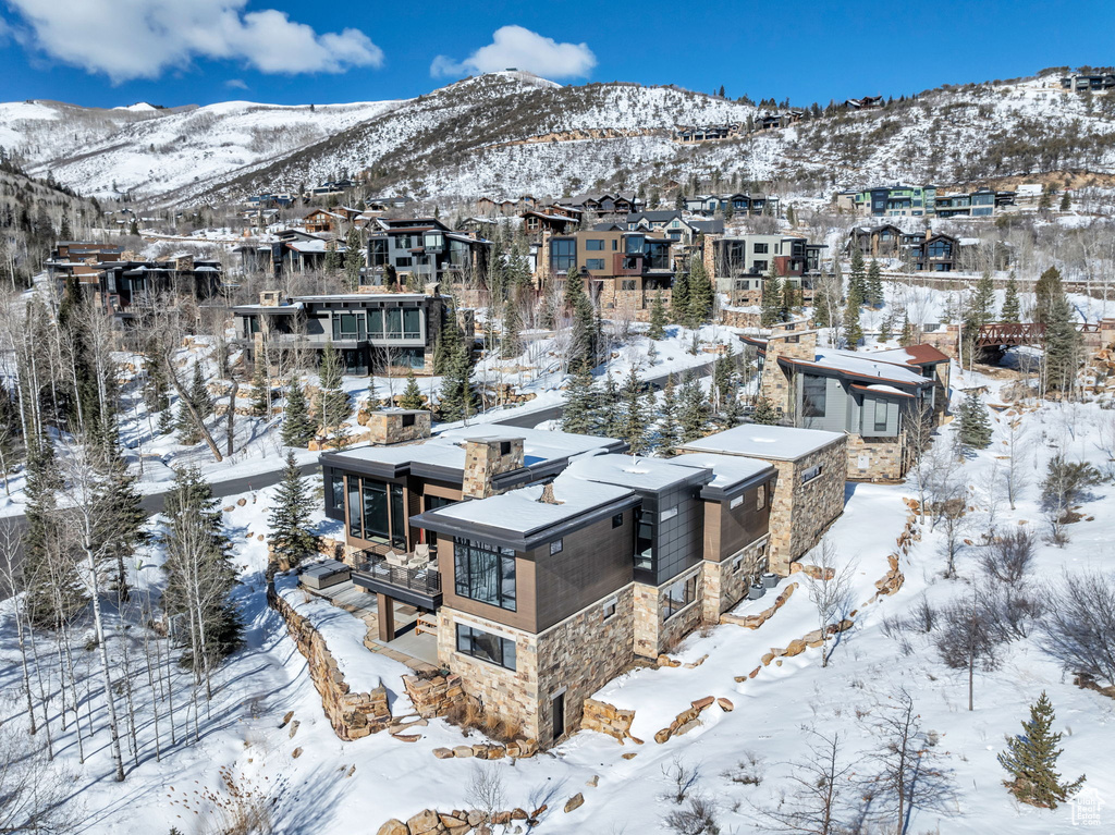 Snowy aerial view with a mountain view and a residential view