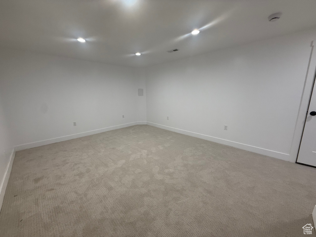 Empty room featuring recessed lighting, baseboards, and light colored carpet