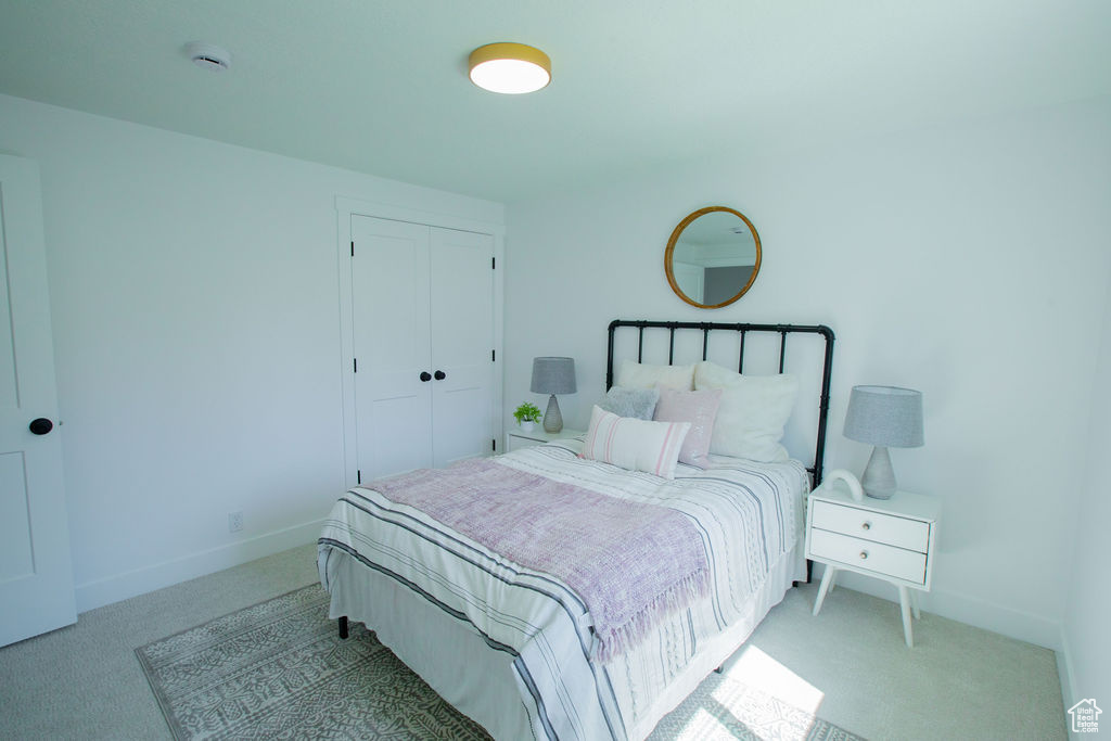 Bedroom featuring carpet floors, a closet, and baseboards