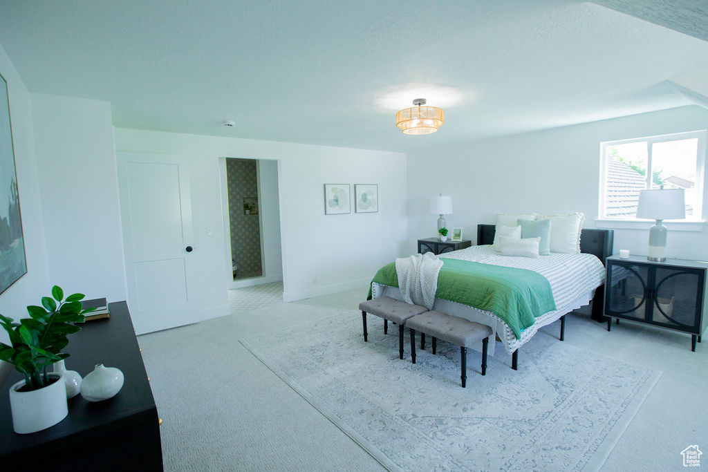 Bedroom with light carpet and baseboards