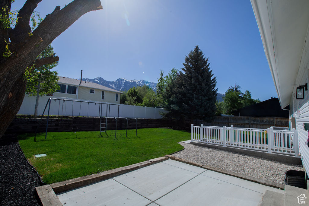 View of yard with a patio and a mountain view