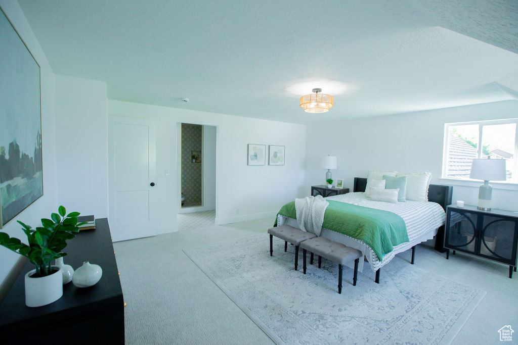 Bedroom featuring light carpet and baseboards