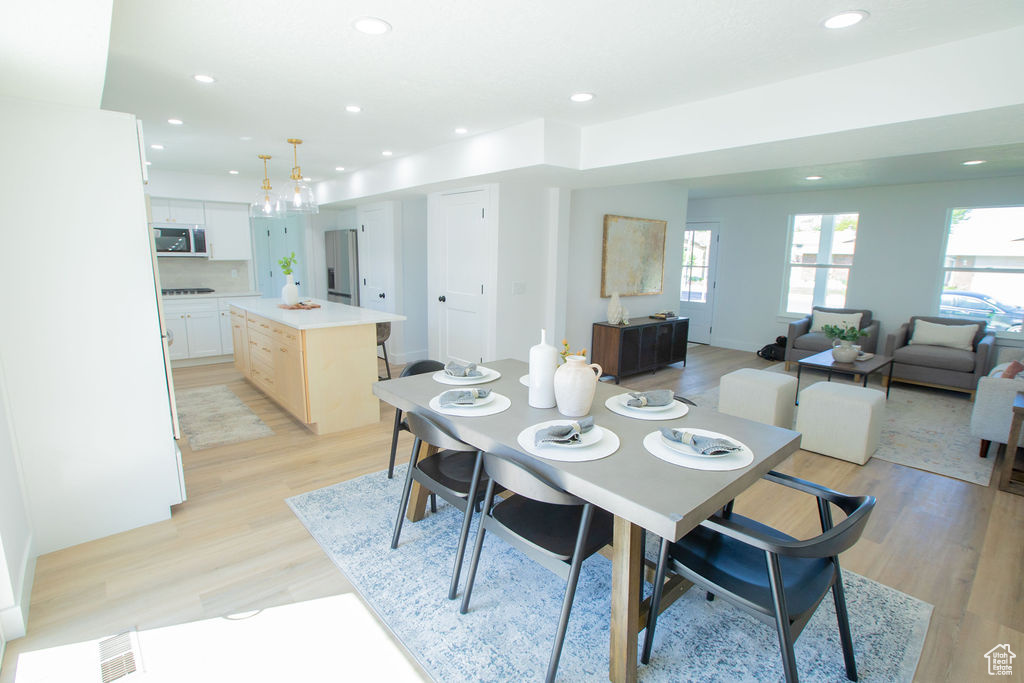 Dining space featuring light wood finished floors and recessed lighting