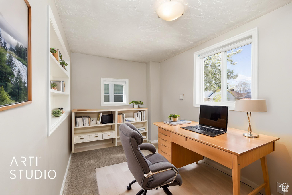 Carpeted office featuring baseboards