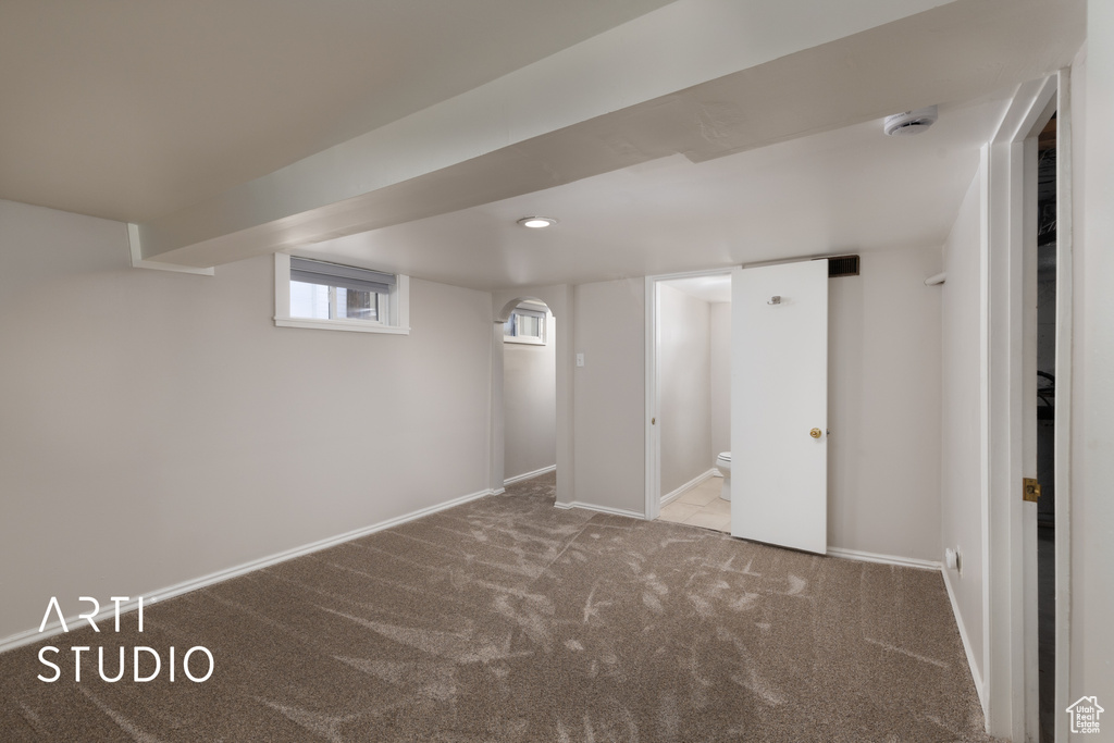 Below grade area featuring carpet and baseboards