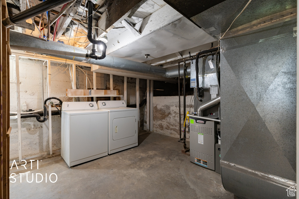 Unfinished below grade area featuring washer and clothes dryer